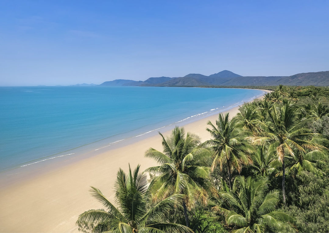 No Place I’d Rather Be aerial view of Four Mile Beach, with tranquil blue waters and soft sand tones under a clear sky – coastal tranquility print.