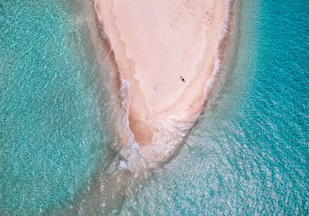 Sun bathing in the sand on a deserted coral sand cay on the great barrier reef